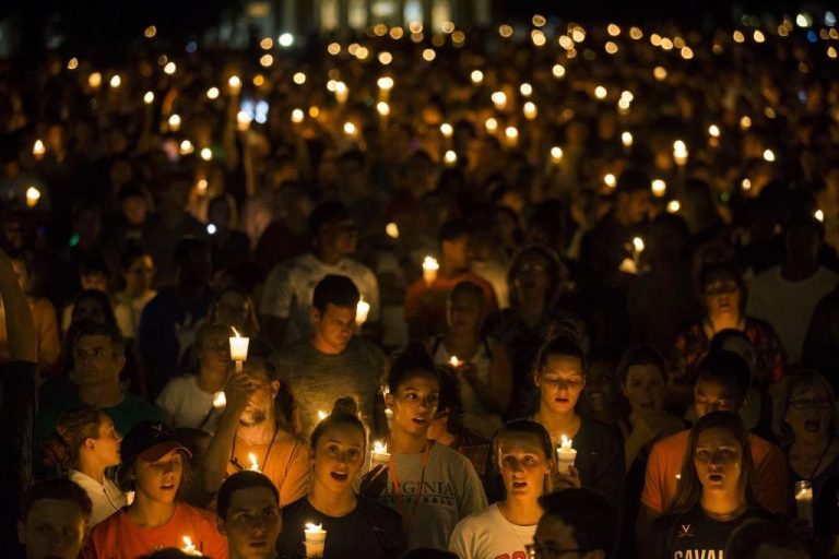 Thousands gather with candles on the University of Virginia Campus in Charlottesville, VA