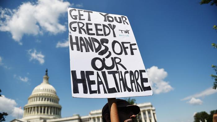 Get your hands off our healthcare protest sign