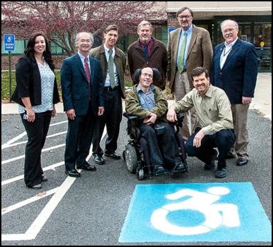 Self-advocates with handicapped parking sign